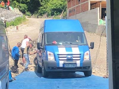 A van being dug off the ferry