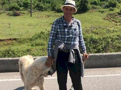 An Albanian farmer with his dog