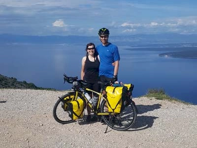 Zoe and Stewart stood with their touring bike on Island Cres