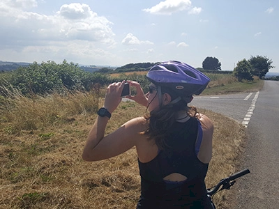 Zoe Ashbridge taking a picture on the John O' Groats to Lands End cycle tour
