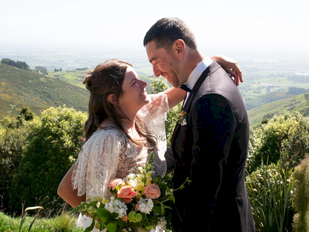 Zoe and Stewart stood at the Port Hills New Zealand in a wedding dress and suit moments before they were officially married