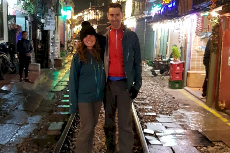 Zoe and Stewart stood on the train tracks on the famous Hanoi Train Street