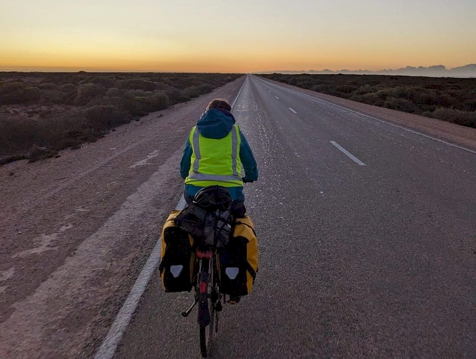 Zoe cycling to Nullarbor roadhouse as the sun is rising