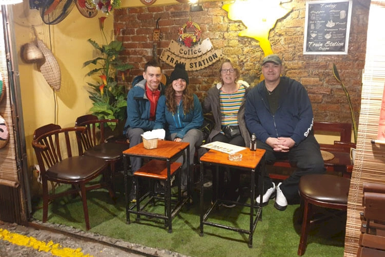 family photo at a restaurant on train street