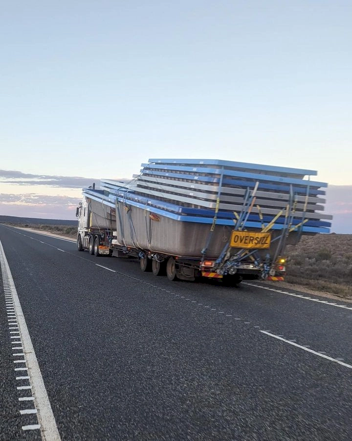 oversized vehicle on Nullarbor plain carrying swimming pools